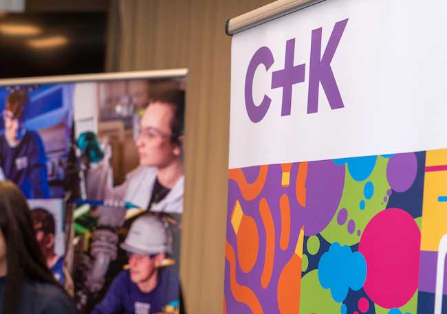C+K stand next to another exhibitor stand at a C+K event